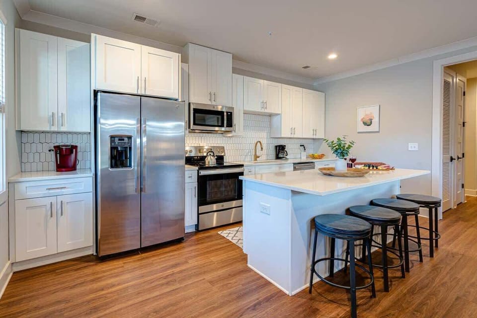 Fully equipped kitchen boasting stainless-steel appliances and stocked with all culinary essential for your convenience.