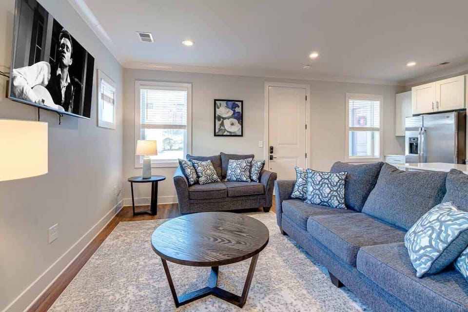 Open-floor plan featuring the cozy living room furnishings with a Smart TV seamlessly connecting to the fully equipped kitchen.