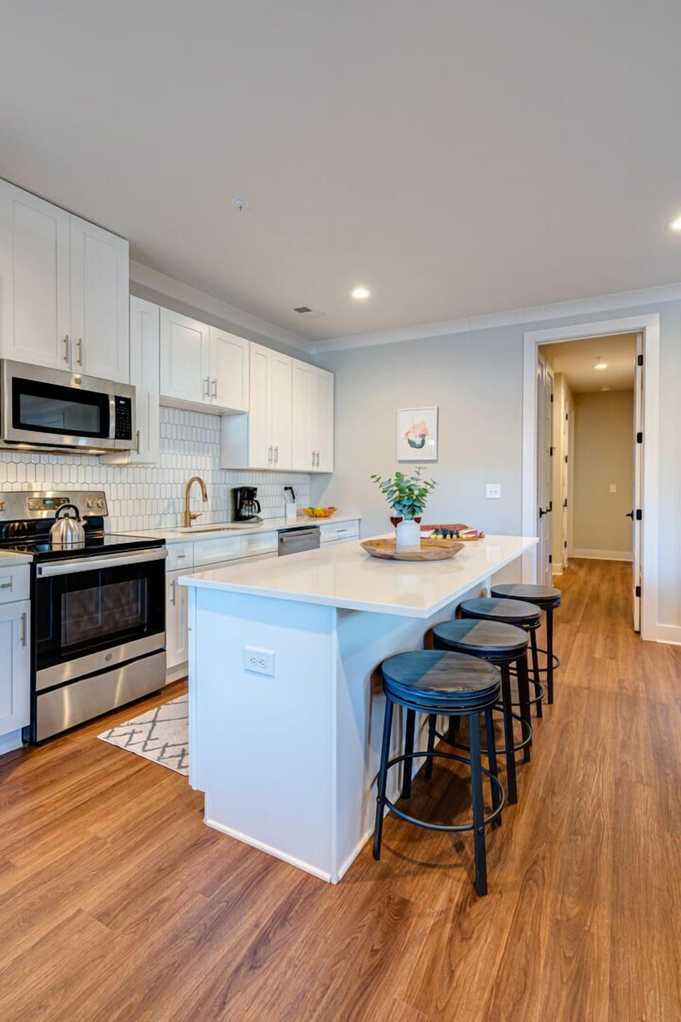 Fully equipped kitchen boasting stainless-steel appliances and stocked with all culinary essential for your convenience.