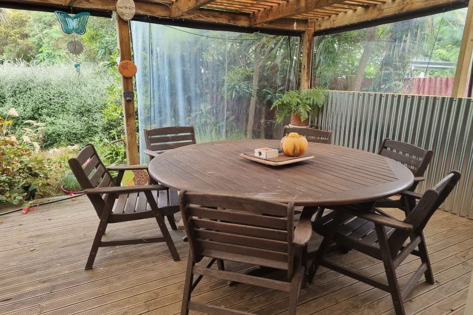 Large covered in outdoor table and chairs accommodates 8 people