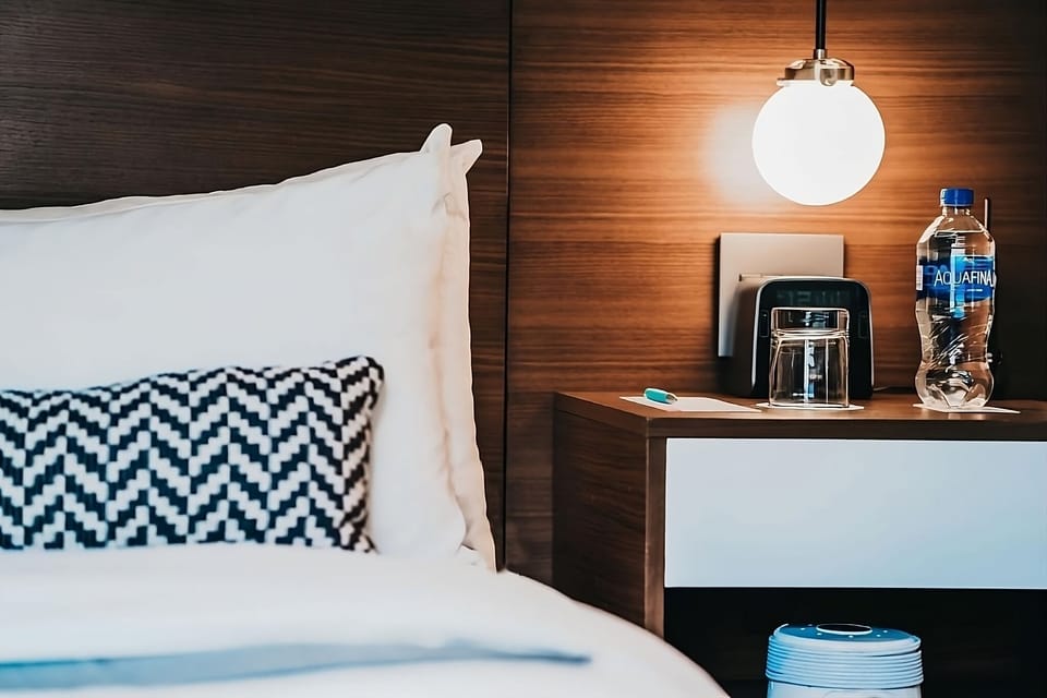 Enjoy bedside convenience with warm lighting and fresh essentials.