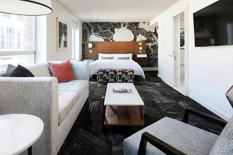 Unwind in a sunlit suite with designer textures and comfort.
