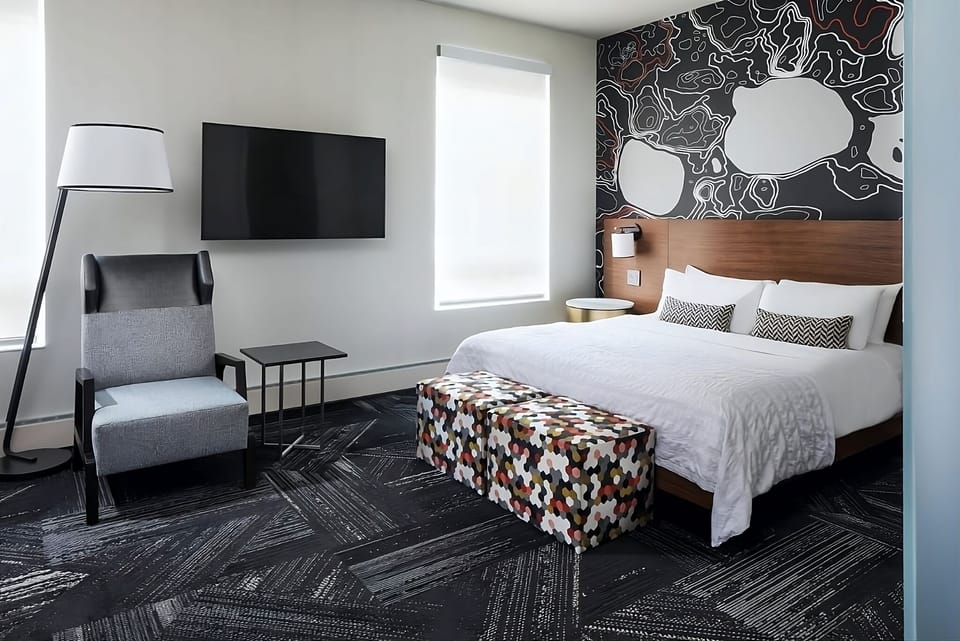Unwind in a stylish king room with bold designer art.