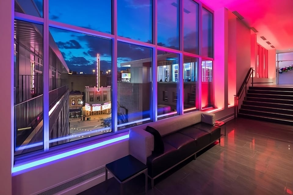 Unwind on sleek seating with vibrant evening city lights.