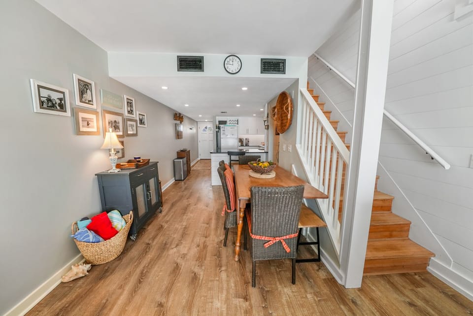 Your cozy dining area flows seamlessly into the kitchen, with warm wood floors and charming personal touches creating the perfect space for memorable meals.
