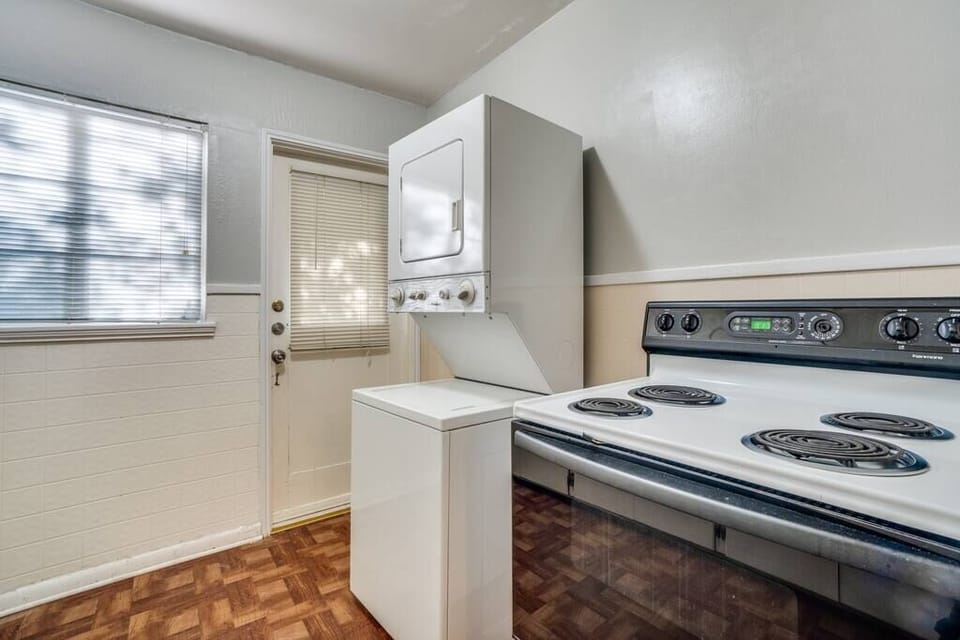 Washer/dryer by the backdoor to the yard
