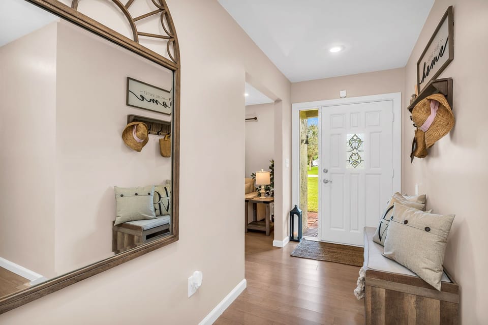 As you enter the front door, you are welcomed by a warm, homey atmosphere. There is an entrance bench, farmhouse throw pillows and rustic wall décor.