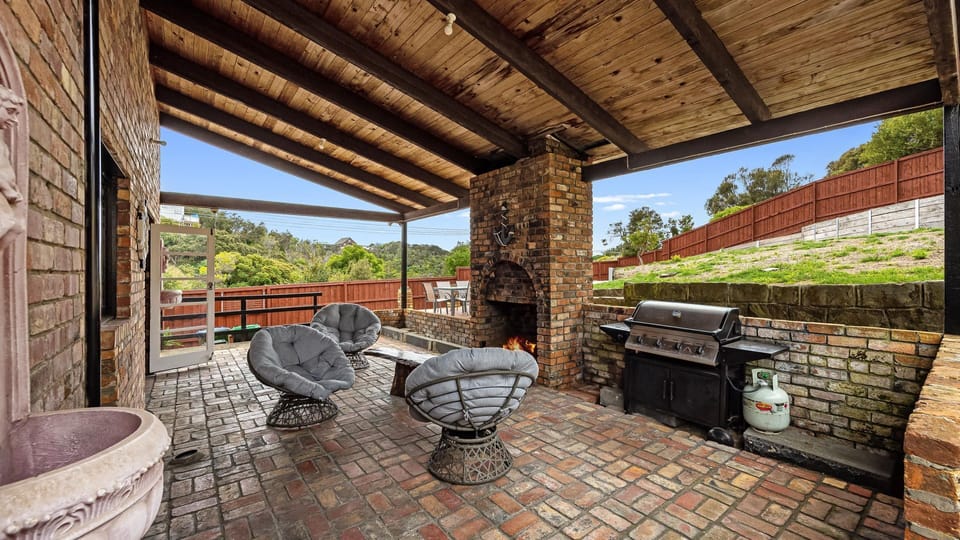 Sheltered by a large overhang and set with rattan cushioned chairs, the patio is a magical spot.