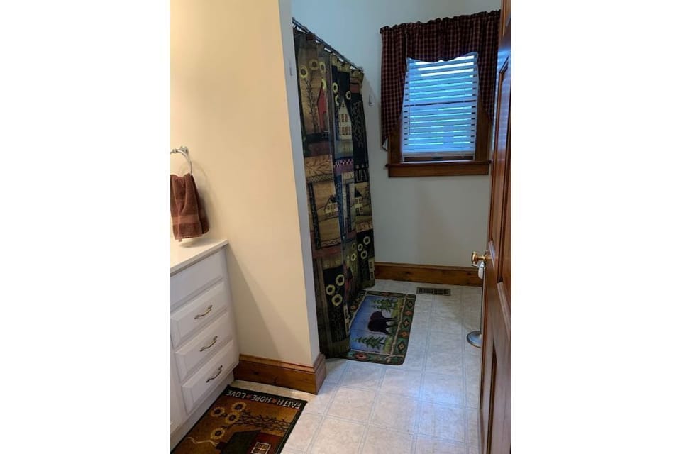 Full bathroom with shower and washer dryer