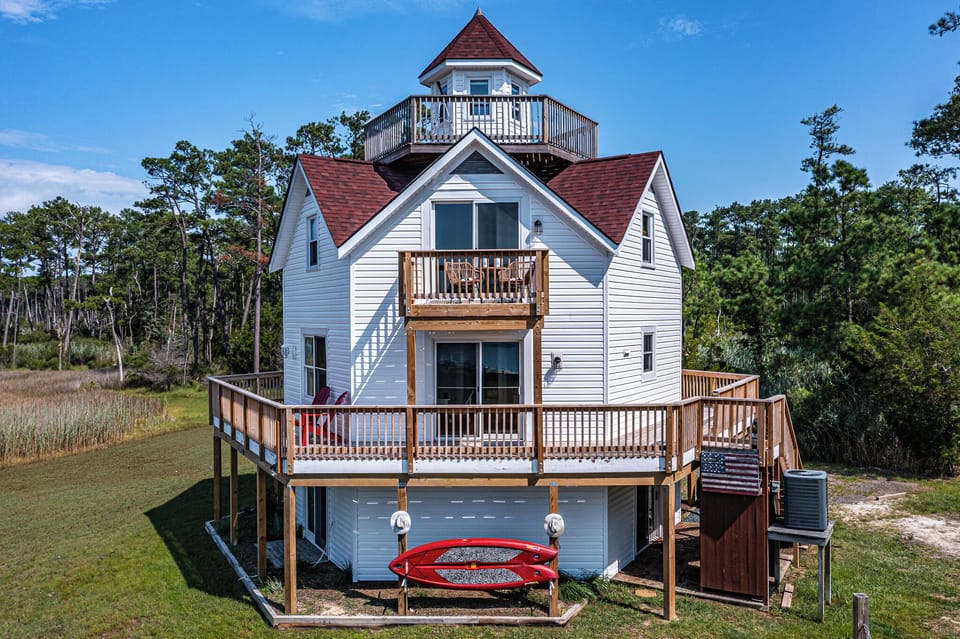 Showing sliding glass door that leads out to wrap around deck with stairway to the yard.