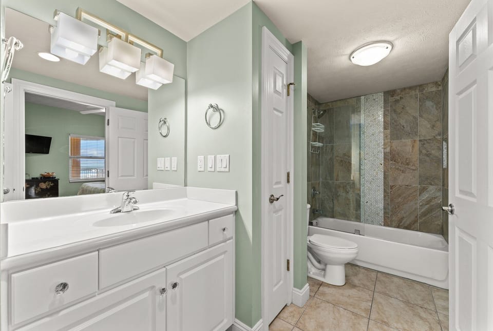 Modern bathroom with a tiled shower and spacious vanity.