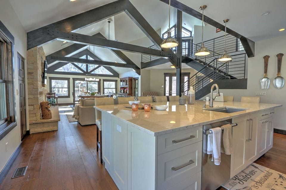 Pristine open concept chef`s kitchen w/ large island and breakfast bar seating