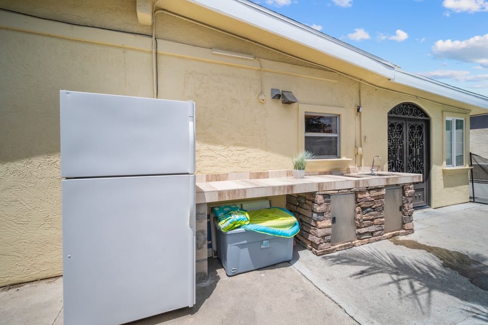 Backyard retreat with bowling, mini golf, bar, fire pit, and grill fun.