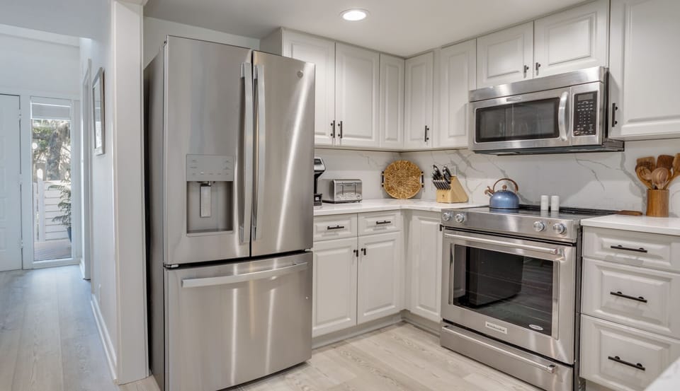 The tile flooring keeps the space cool and practical, while recessed lighting provides even, inviting illumination throughout.