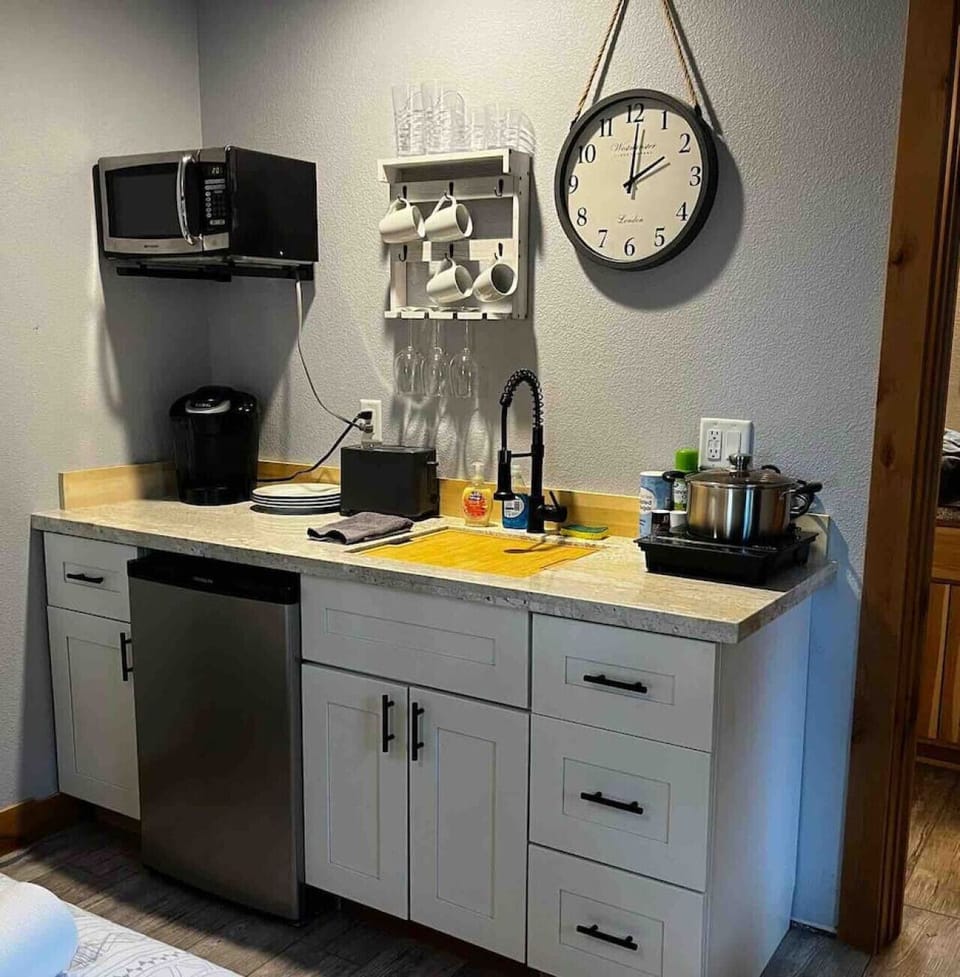 Kitchenette with Induction burner, fridge, Keurig coffee maker, and microwave.