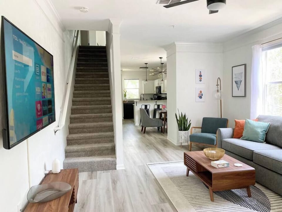 Step into a stylish open-concept layout with modern furnishings and a warm, welcoming vibe.