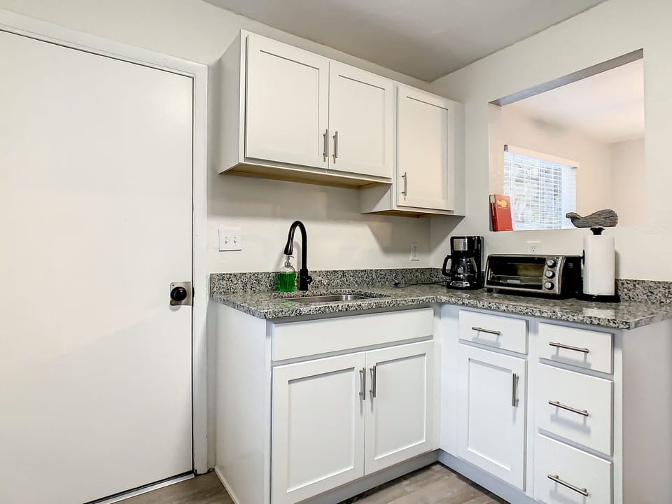 Kitchen looking towards backdoor and laundry