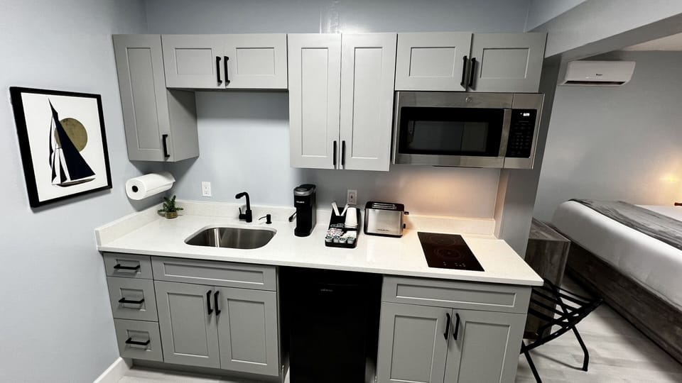 Kitchenette is equipped with mini fridge, microwave, toaster, coffee machine