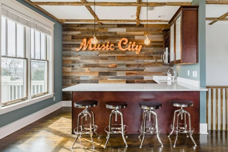 - Fun bar area with Music City sign and rustic wood accent wall   - Cozy seating and bright windows create a lively hangout   - Perfect for drinks conversation and Nashville themed vibes