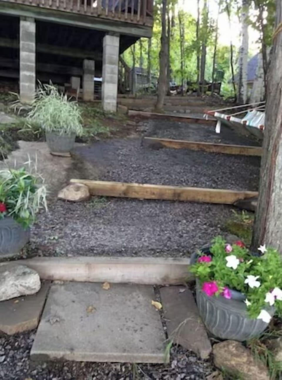 large gravel path/steps going down to the lake from the side of the cottage.  