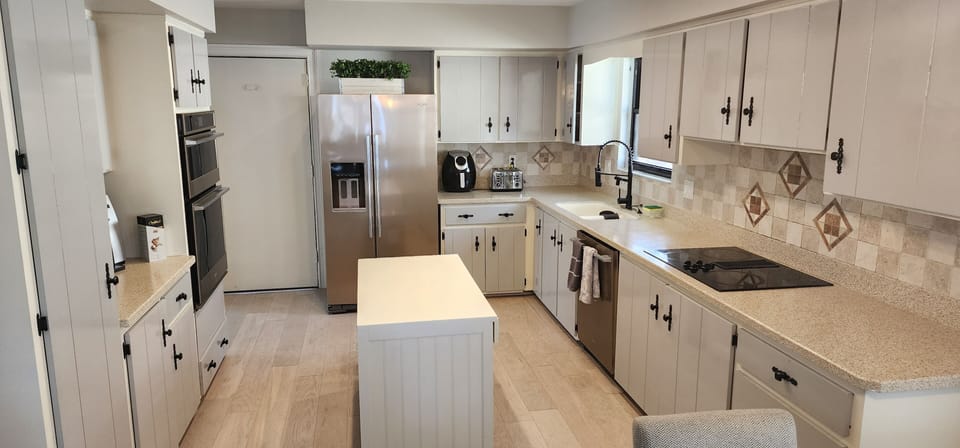 Stocked kitchen with new stainless appliances