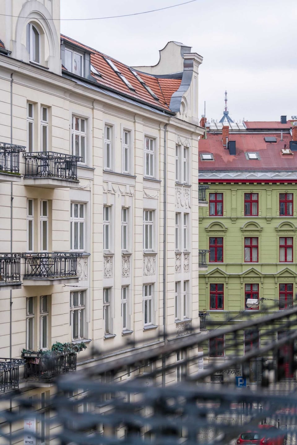 A charming city view from the apartment window, showcasing colorful historic buildings.
