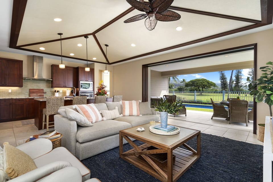 Bright great room with vaulted ceilings, comfortable seating, and golf course views.