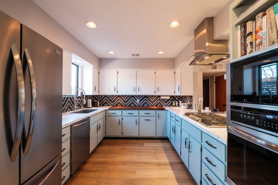 Newly updated kitchen with stainless steel appliances and dramatic decor.