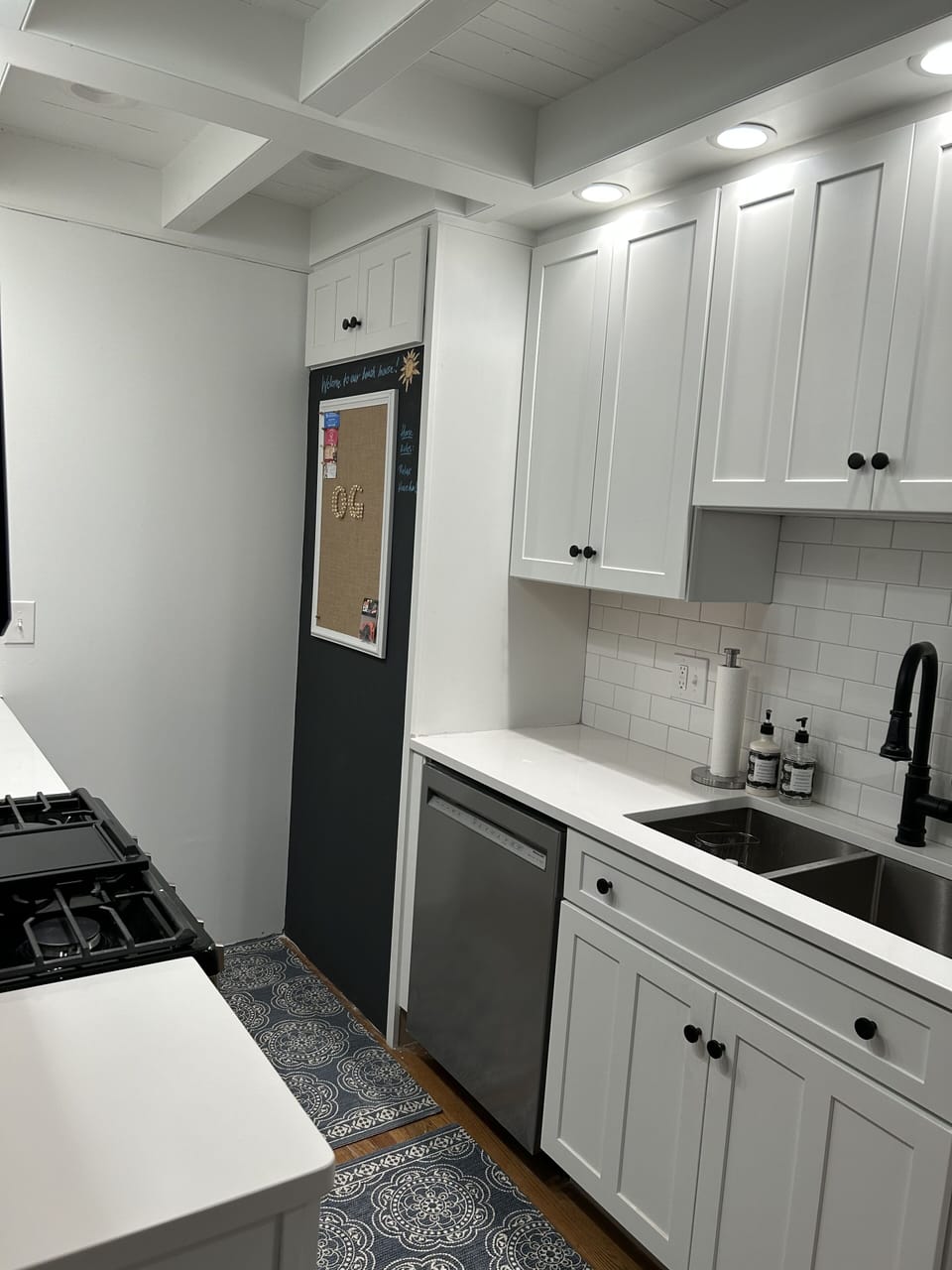Updated kitchen with new appliances. Door opens to backyard with new grille.