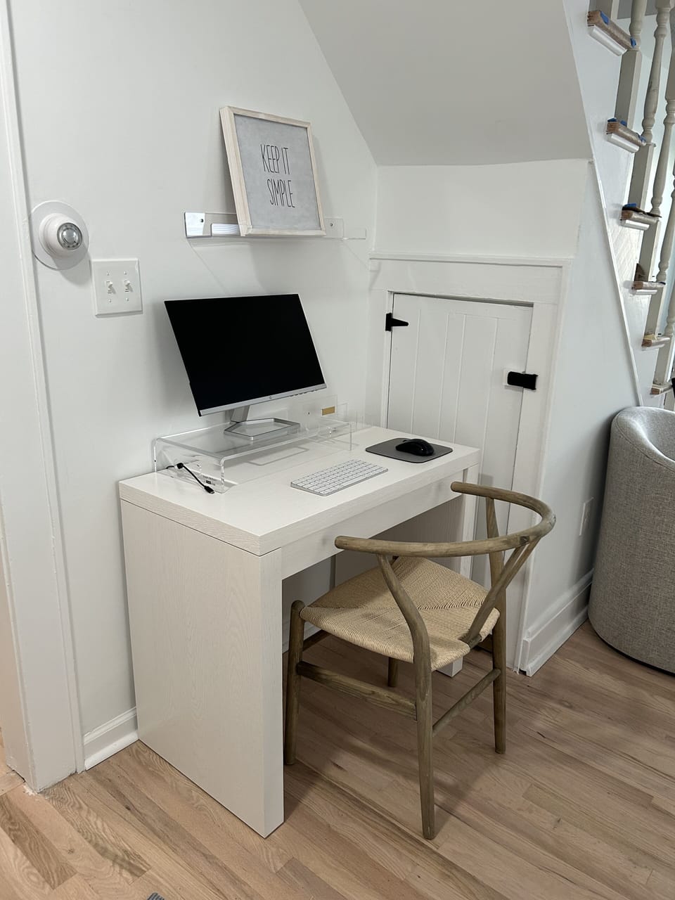 Office area with blue tooth apple keyboard and monitor. 