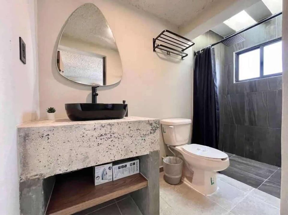 Full private bathroom with vanity and mirror
