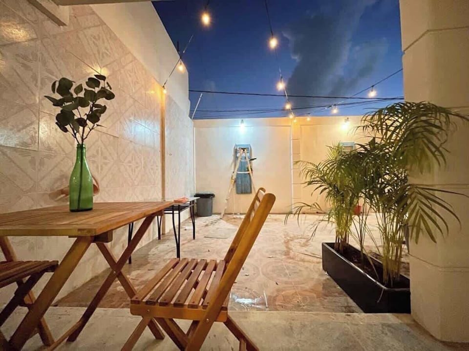 Terrace table and chairs with plants (shared area)