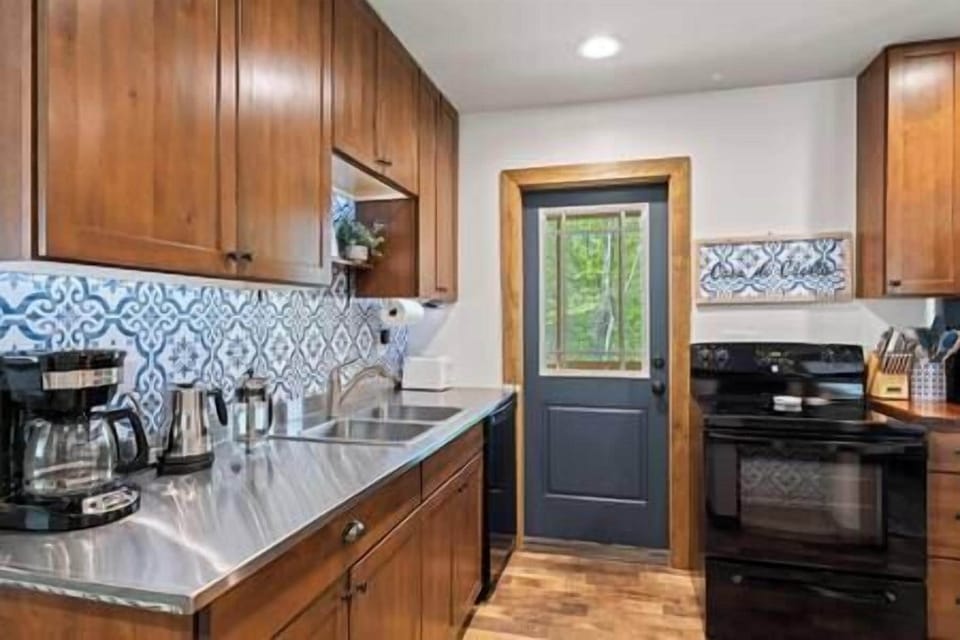 A fully-equipped kitchen that leads to the porch.