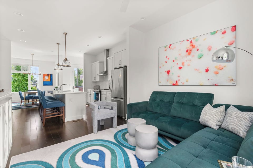 - Open layout connecting living room and kitchen beautifully   - Modern seating and colorful art enhance your stay   - Great vacation rental space for groups and families