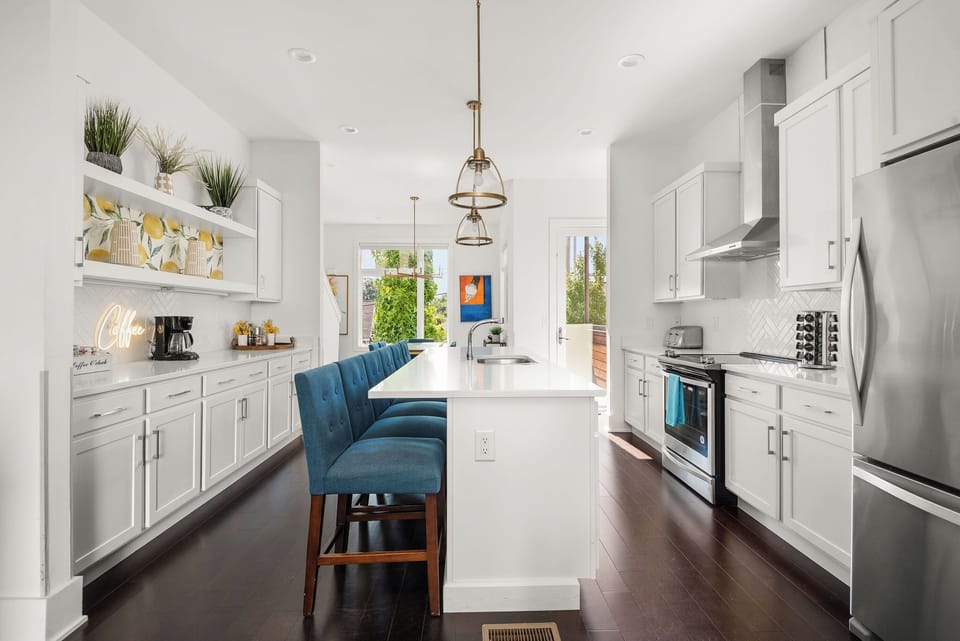 - Spacious kitchen with bright cabinets and sleek appliances   - Large island seating ideal for group cooking and dining   - Modern vacation rental setup with stocked essentials