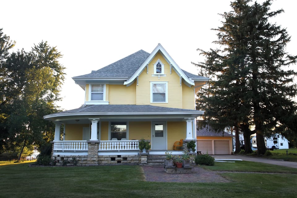 1910 farmhouse.  Wrap around porch on 4.5 acres of land. Summer view.