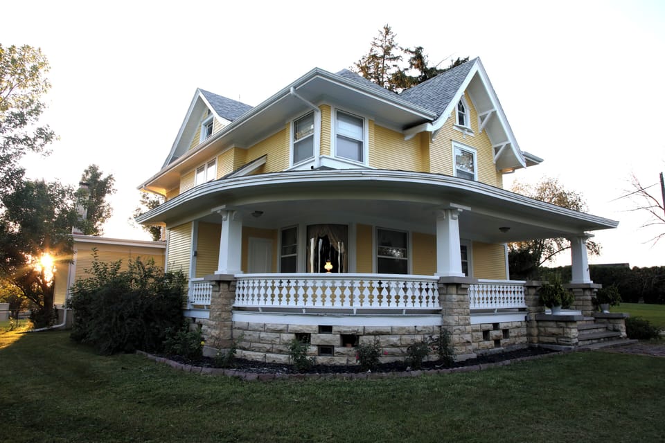 Wrap around porch.  Notice the curved window.