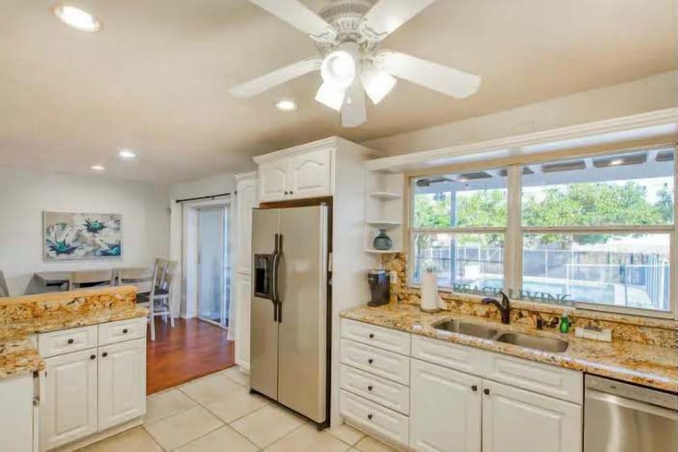 "Whip up something delicious in our updated kitchen! Featuring stunning granite counters and stainless steel appliances, this vacation home is ready for all your culinary adventures. 🍳🍷"