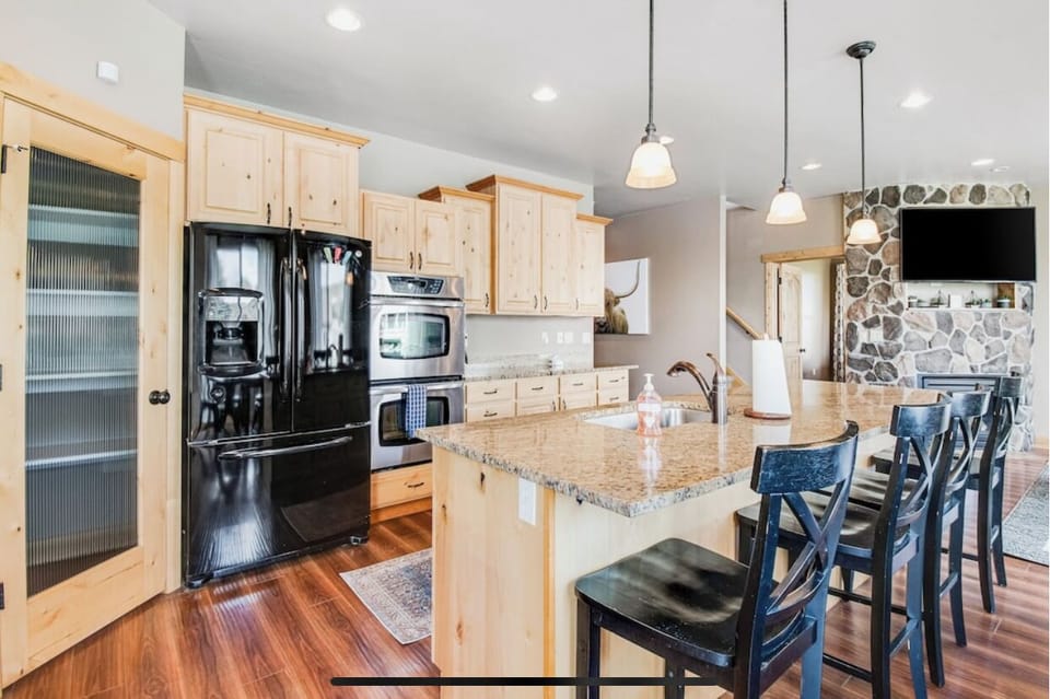 Kitchen with island.  Island has 4 bar chairs.