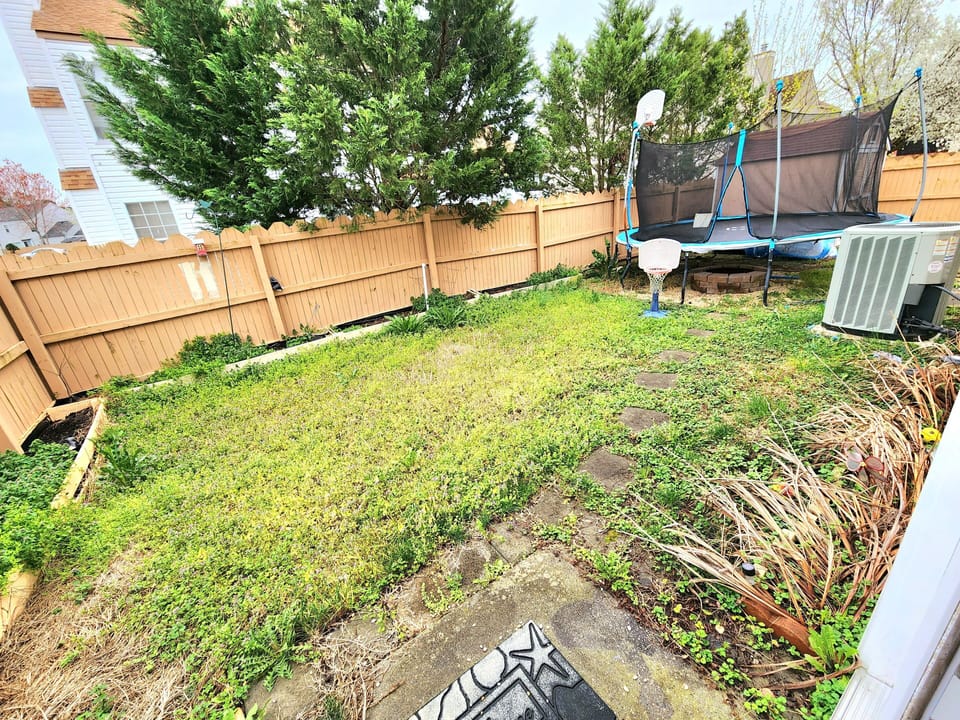 Backyard with trampoline and basketball court for your little ones to play. 