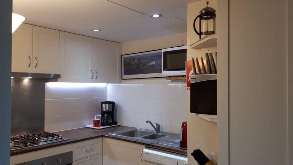Kitchen with Oven, Cook Top, Coffee Maker, Sink and Microwave Oven.