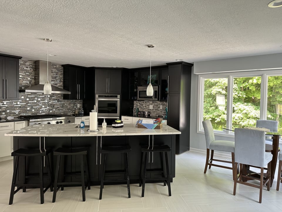 The kitchen with island and 4 barstool and farmhouse sink.