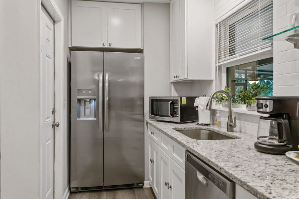 Kitchen features bar area, oven, stove, dishwasher, microwave, large cabinet space, and all amenities.