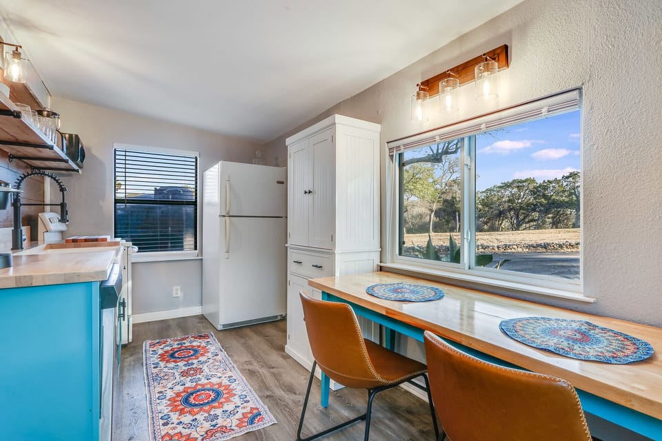 Full kitchen with a stove, oven, refrigerator, and coffee maker