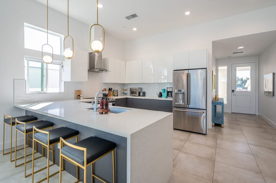 Fully equipped kitchen with stove, oven, air fryer, microwave, coffee maker, toaster, and dishwasher. Plenty of space for seating and entertaining.