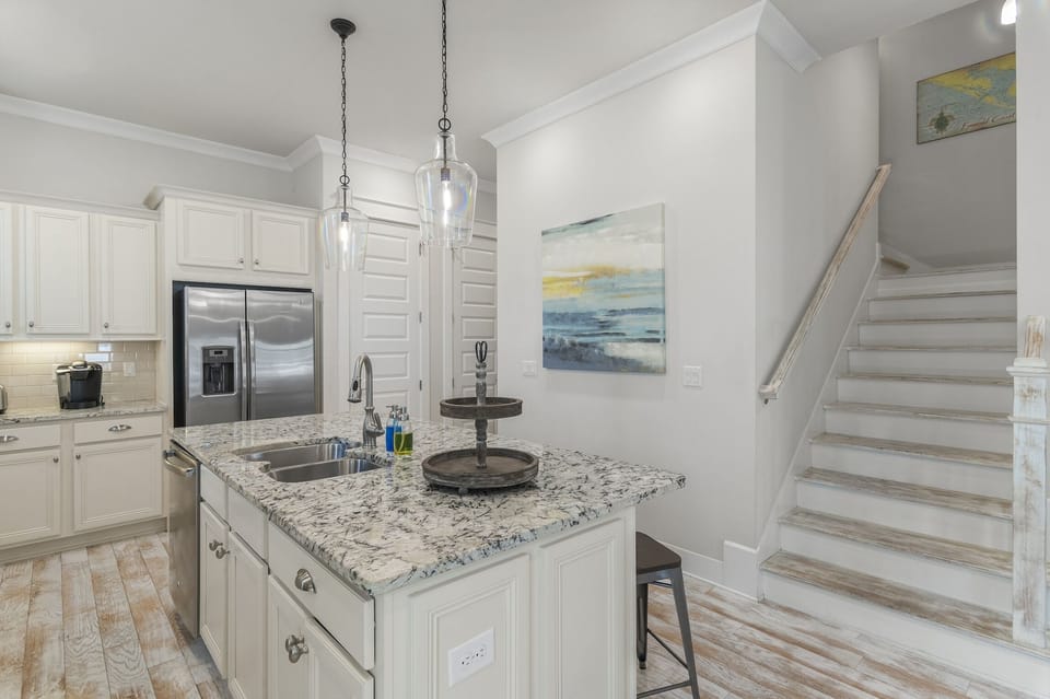 View of kitchen with access to the second floor of the home.