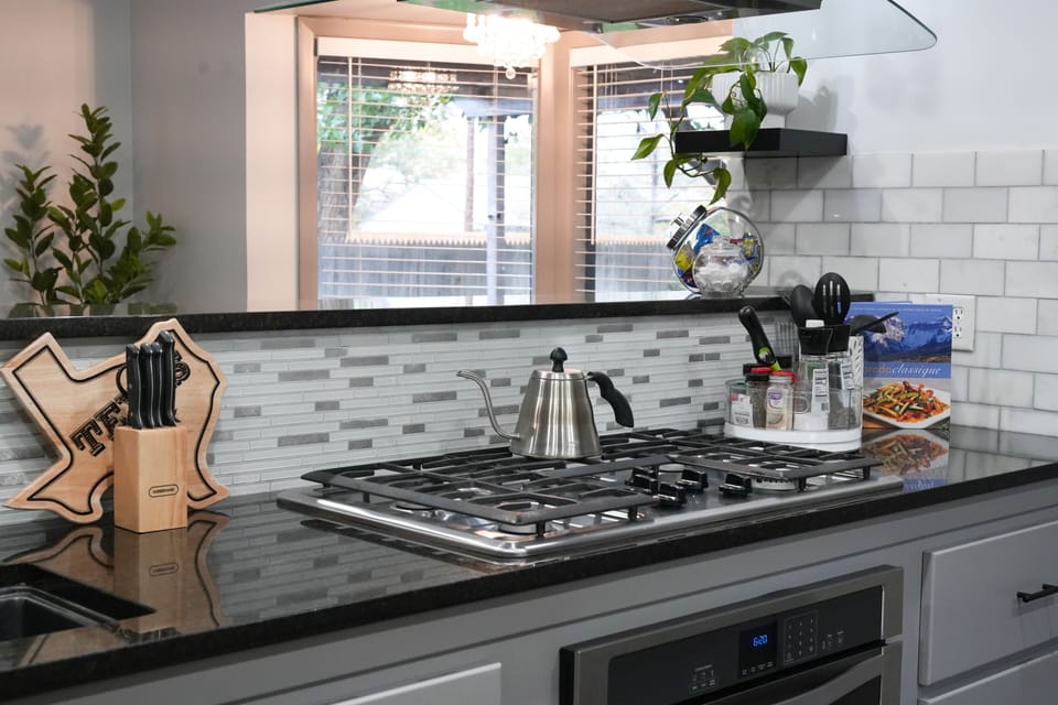 Five burner gas stove and fully stocked kitchen
