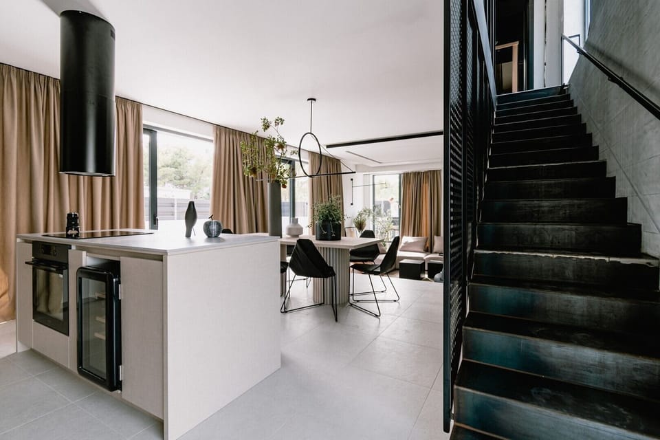 Modern air conditioned interior of the bright ground floor with fully equipped kitchen, a dining area and internal staircase in the new pet friendly summer home villa Noir Vodice 