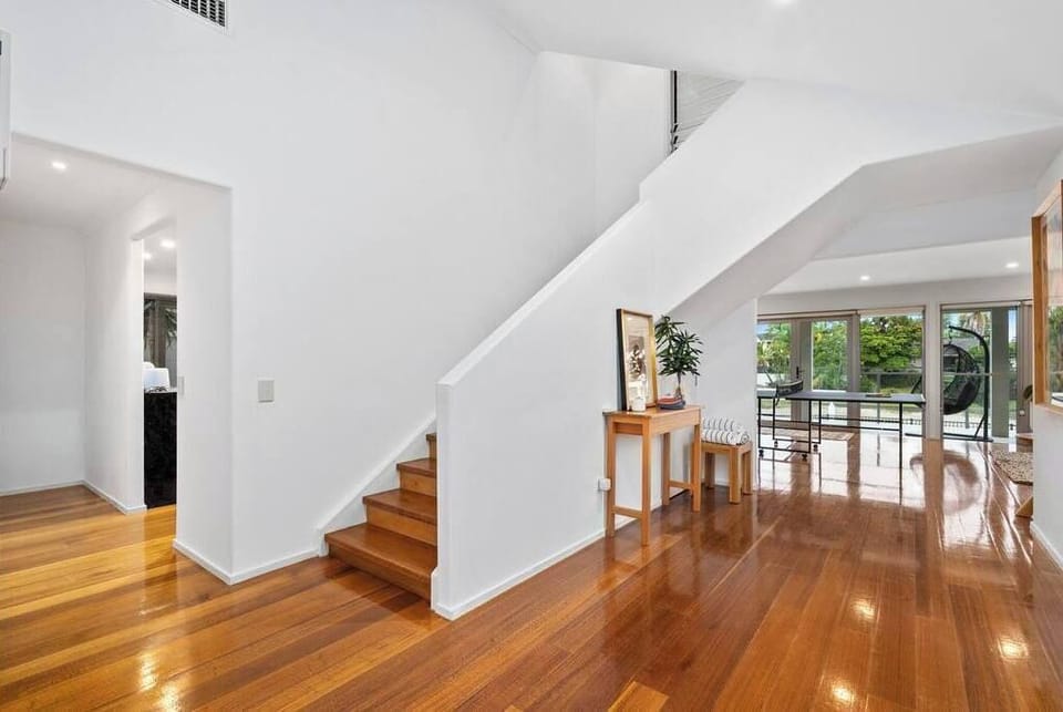 Staircase links ground-floor bedrooms and living areas to private upper retreat.