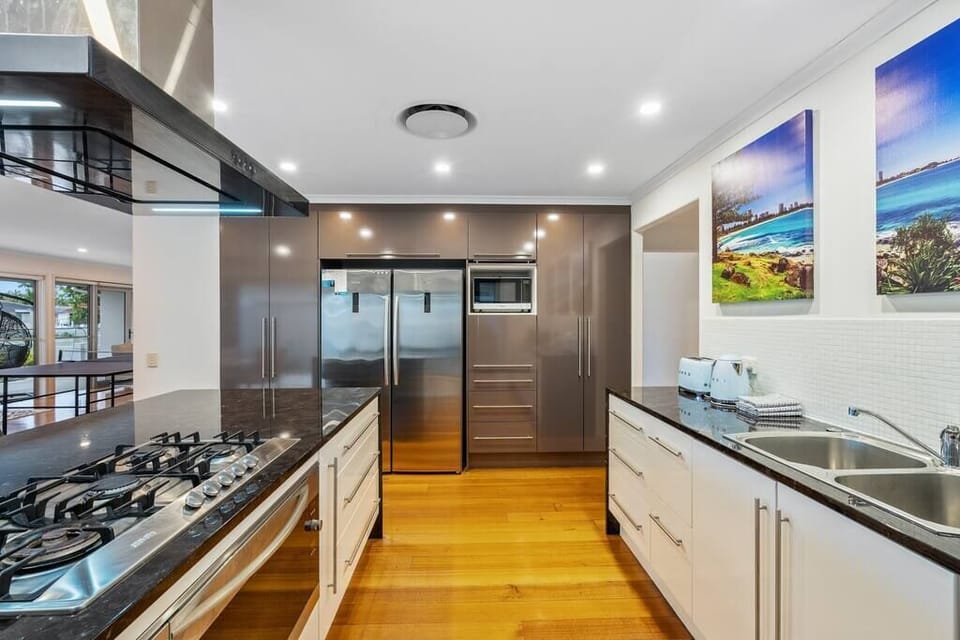 Gas cooktop, oven, fridge, bar seating and dining space support easy meals here.